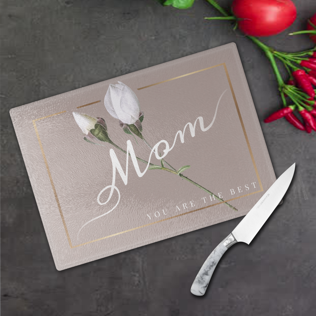 Personalised Floral Glass Cutting Board "Mom You Are The Best" from Happy Look | South Africa – A rectangular glass cutting board with a soft taupe background framed in gold. It features an image of a white tulip and the text in script: "Mom YOU ARE THE BEST." Perfect gift for Mother's Day or birthdays.
