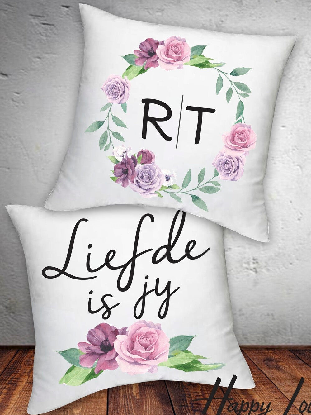 Personalised Floral Initial Cushion Set of two white cushions with floral wreaths, one with monogram initials (R|T) and the other with the Afrikaans text "Liefde is jy" from Happy Look | South Africa.