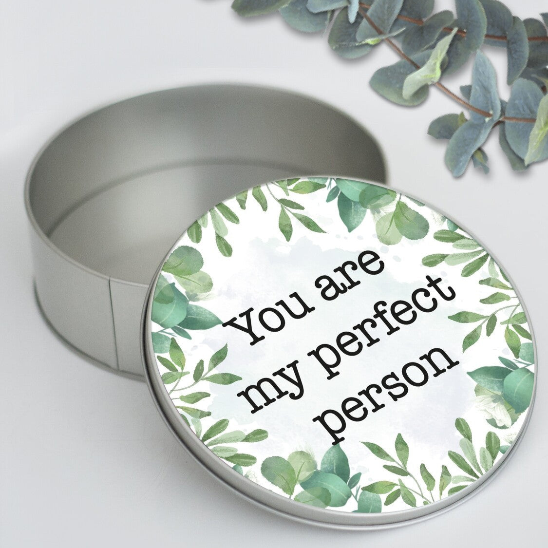 Personalised Round Metal Box from Happy Look | South Africa – A sleek and stylish metal tin customised with a message of your choice and a green leavy bordered design Ideal for birthdays or any special occasion. Customise with a unique message to create a cherished keepsake. Shop now!