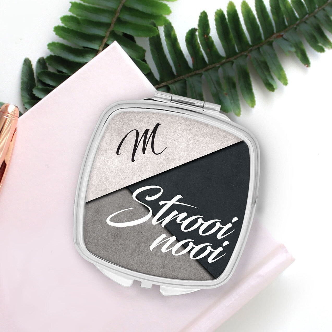 Personalised Pocket Mirror from Happy Look | South Africa β Styled with a chic black and grey theme featuring the name "M" and the word "Strooinooi." Perfect for modern brides and customisable with names. A thoughtful gift that brings joy and lasting memories. Shop now!