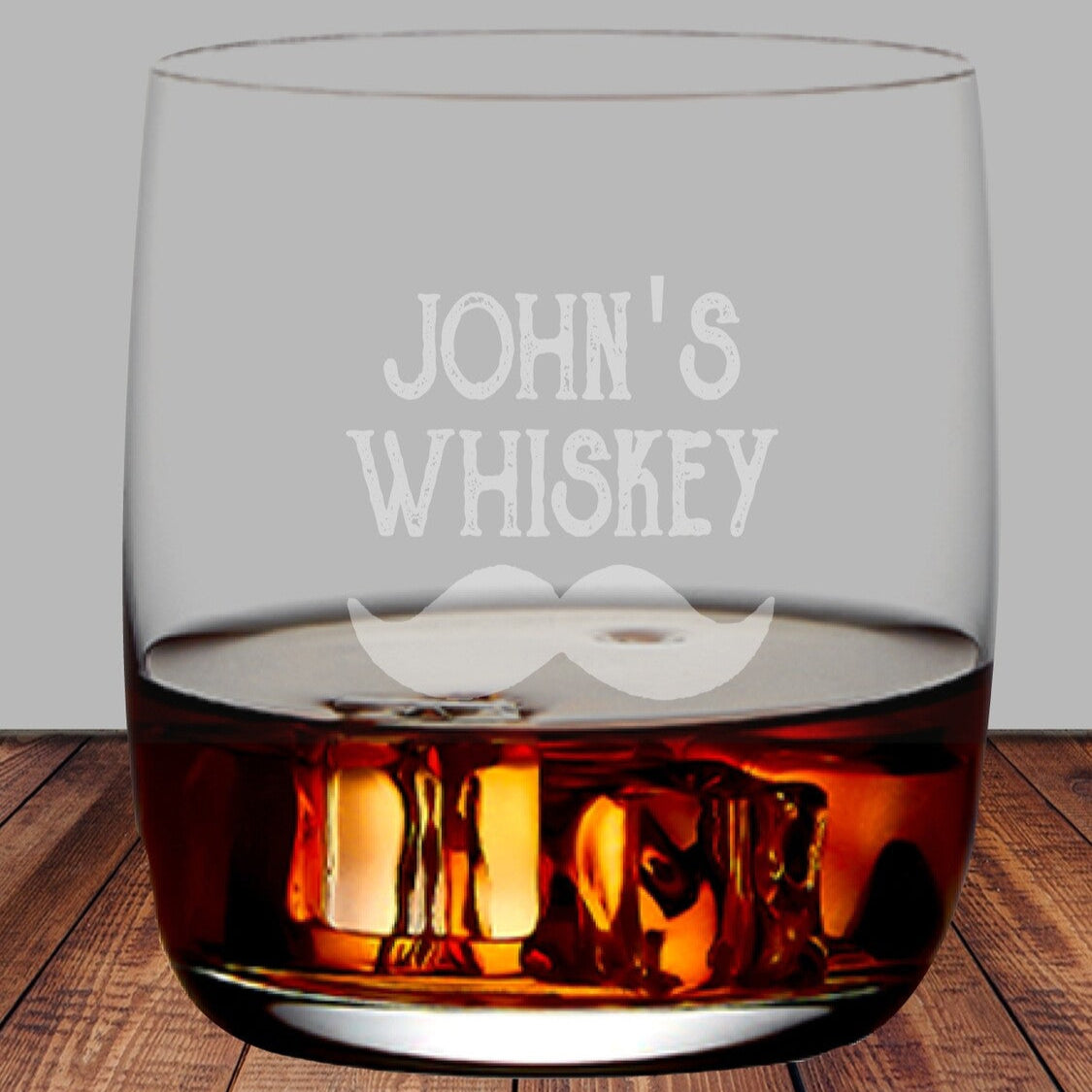 Personalised Engraved Whiskey Glass from Happy Look | South Africa – A sleek and durable glass, expertly engraved with a custom name or message, perfect for whiskey lovers. Perfect for birthdays, anniversaries, weddings, Father’s Day, housewarmings, and corporate gifting, and customisable with a name, initials, date, or special message. A thoughtful gift that brings joy and lasting memories. Shop now – A personalised whiskey glass with the text "John's Whiskey" and a decorative mustache.