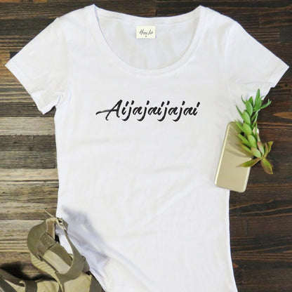 White South African-themed “Aijajai” t-shirt flat lay on wooden background. Fun and relatable local slang design printed on a premium-quality cotton tee by Happy Look, South Africa.