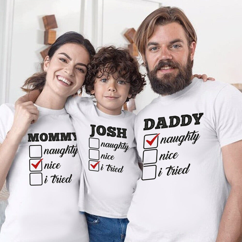 Matching Family Christmas T-Shirts "Mommy/Daddy/Josh Naughty Nice" from Happy Look – White t-shirt set for a family of three (Mommy, Daddy, Josh) with a "Naughty/Nice" checklist design; the 'Nice' box is checked on all. Great for family holiday photos or gifts.
