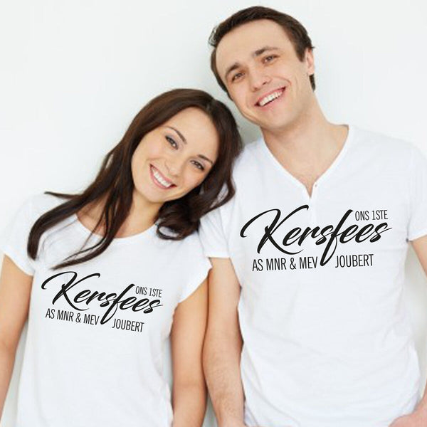 Matching Couple T-Shirts "Ons 1ste Kersfees As MNR & MEV JOUBERT" from Happy Look – White t-shirts printed with the Afrikaans text "ONS 1STE KERSFEES AS MNR & MEV JOUBERT" (Our 1st Christmas as MR & MRS JOUBERT) in black script. Ideal for newlyweds or engagement gifts.
