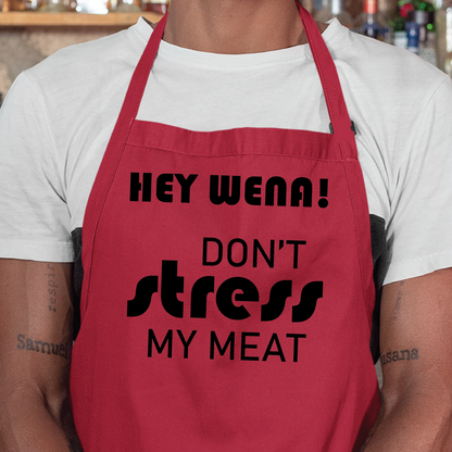 Personalised apron from Happy Look | South Africa – A bold red apron displaying "HEY WENA! DON’T STRESS MY MEAT" in stylish text. Perfect for grilling enthusiasts and outdoor parties, and customisable for personal flair. A thoughtful gift that brings joy and lasting memories. Shop now!
