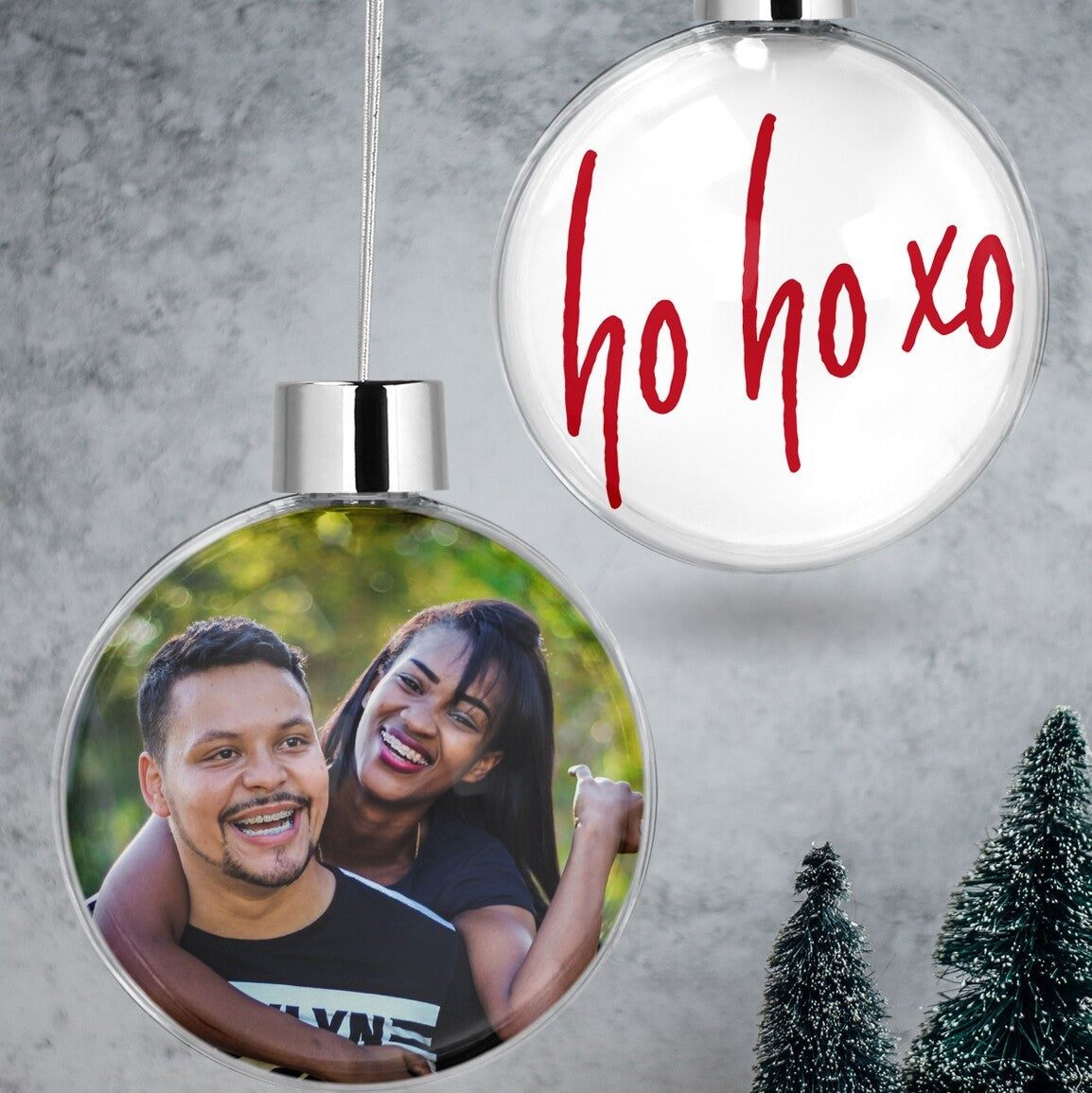 Custom Couple Photo & "Ho Ho Xo" Christmas Bauble from Happy Look | South Africa – A clear hanging Christmas bauble set. One bauble showcases a cheerful couple's photo, and the other is boldly printed with "ho ho xo" in playful red script.