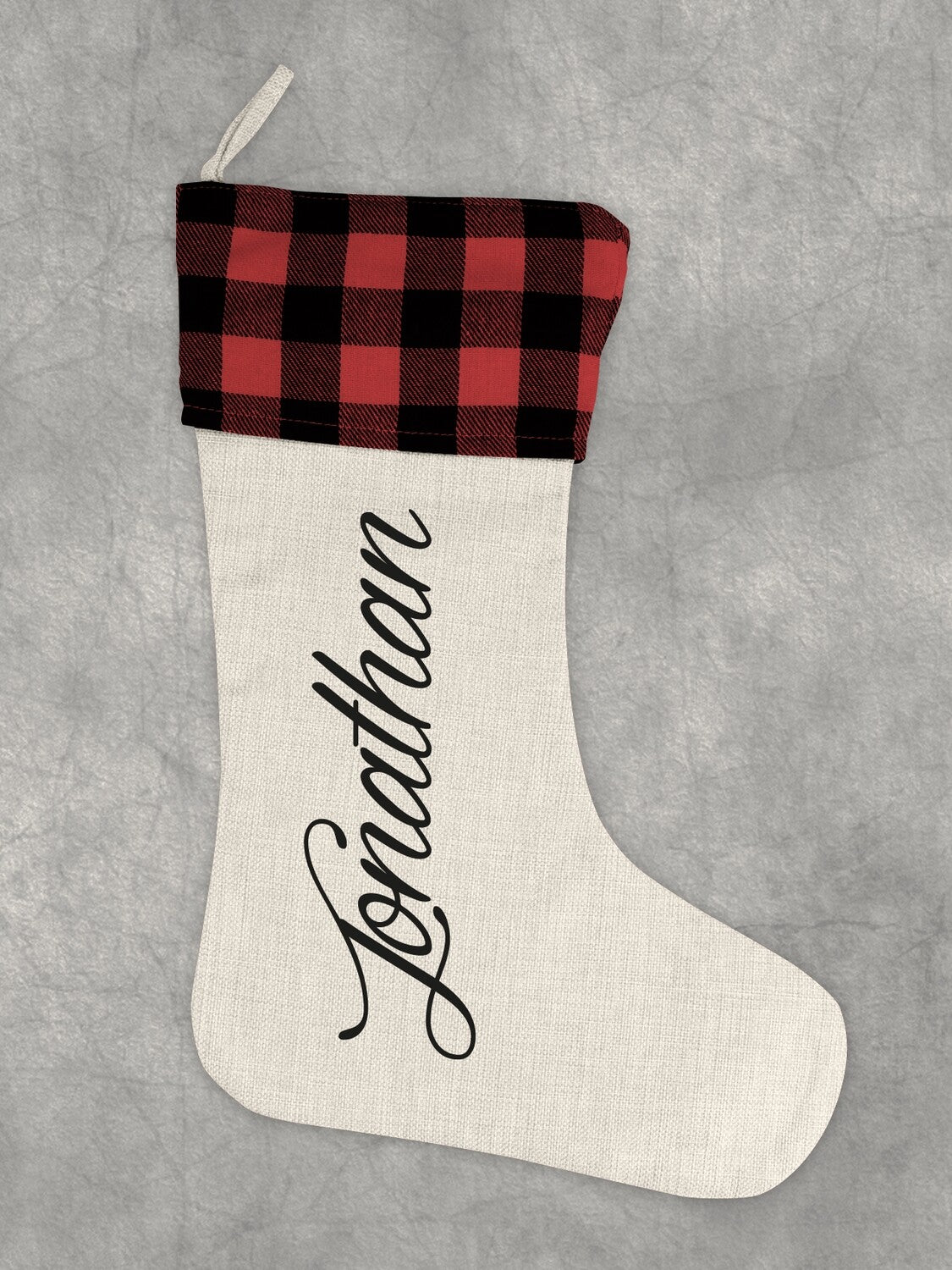 Personalised Name Christmas Stocking "Jonathan" from Happy Look | South Africa – A single cream-colored stocking with a red and black buffalo plaid cuff, printed with the name "Jonathan" vertically in large black script.