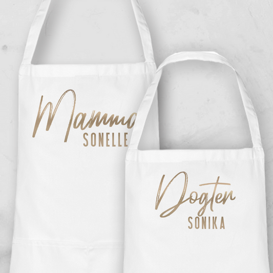 Personalised Apron Set from Happy Look | South Africa

Features two white aprons with custom names: "Mammo Sonelle" and "Dogter Sonika."
Perfect for family occasions and customisable with unique names or titles.
A thoughtful gift that brings joy and lasting memories. Shop now!