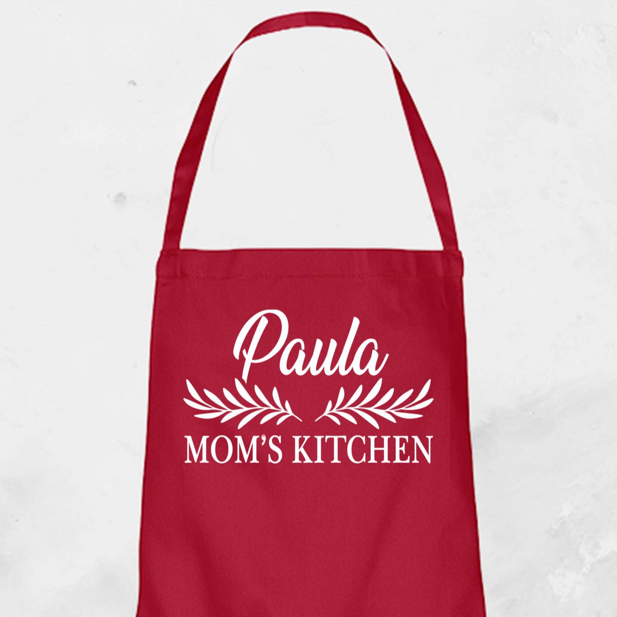Alt TextPersonalised Apron from Happy Look | South Africa – Adorned with "Paula Mom’s Kitchen" in elegant script. Perfect for holidays and customisable with names or kitchen themes. A thoughtful gift that brings joy and lasting memories. Shop now!