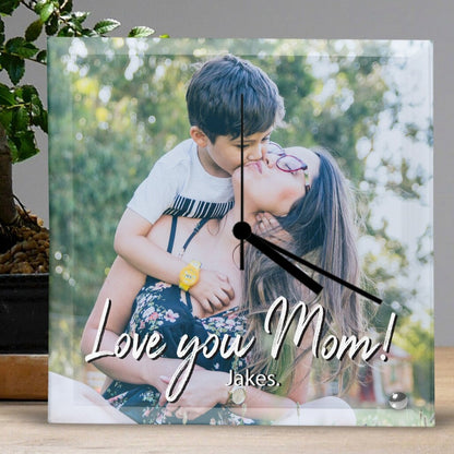 Personalised Square Glass Clock from Happy Look | South Africa – A decorative clock featuring a heartfelt photo of a mom and son, with the loving message "Love you Mom!" and "Jakes" inscribed. Perfect for Mother's Day, birthdays, or any special occasion to show appreciation. Customisable with your own photo for a unique and sentimental touch. A thoughtful gift that