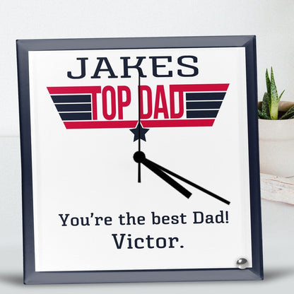 Square Glass Clock with black hands on a white face, featuring 'Jakes Top Dad' in bold red and black text. Below, it reads, 'You're the best Dad! Victor.' Personalised Square Glass Clock from Happy Look | South Africa – A fun and meaningful clock to celebrate an amazing father. Perfect for Father's Day, birthdays, or special occasions, and customisable with your own personal message. A thoughtful gift that brings joy and lasting memories. Shop now!