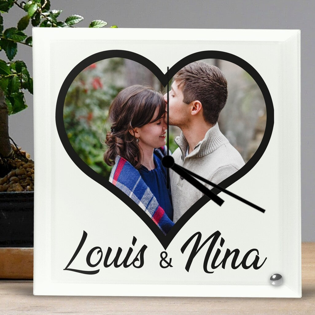 Personalised Square Glass Clock from Happy Look | South Africa – A heart-shaped clock design featuring a couple hugging and kissing, symbolising love and intimacy. Below, elegant script reads "Louis & Nina." The photo is customisable with your own image, making it a unique and heartfelt gift. Perfect for anniversaries, weddings, or special romantic occasions. A thoughtful gift that brings joy and lasting memories. Shop now!