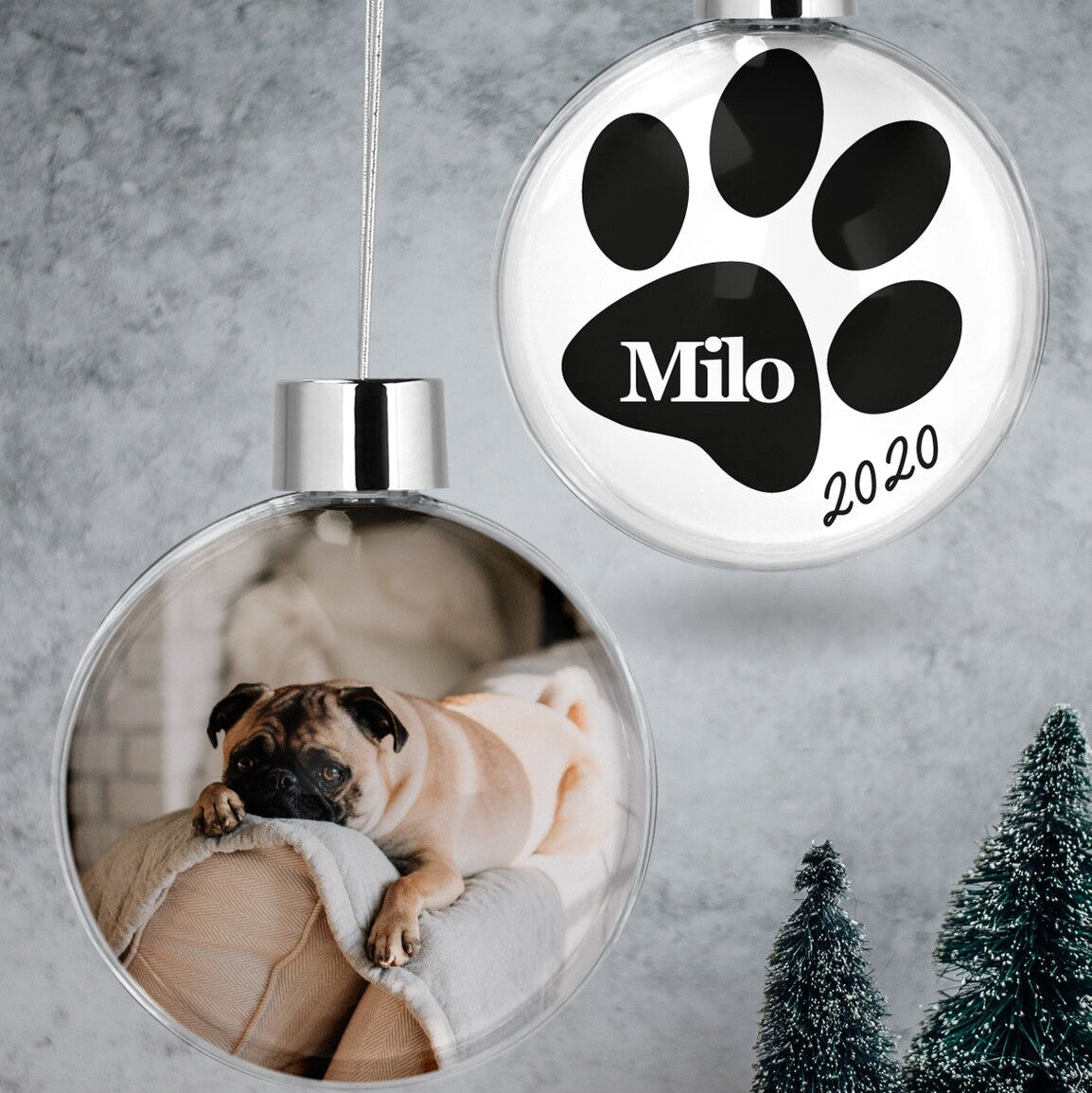 Custom Pet Photo & Paw Print Christmas Bauble "Milo 2020" from Happy Look | South Africa – A clear hanging Christmas bauble set. One bauble has a photo of a pug, and the other displays a paw print, "Milo," and "2020."
