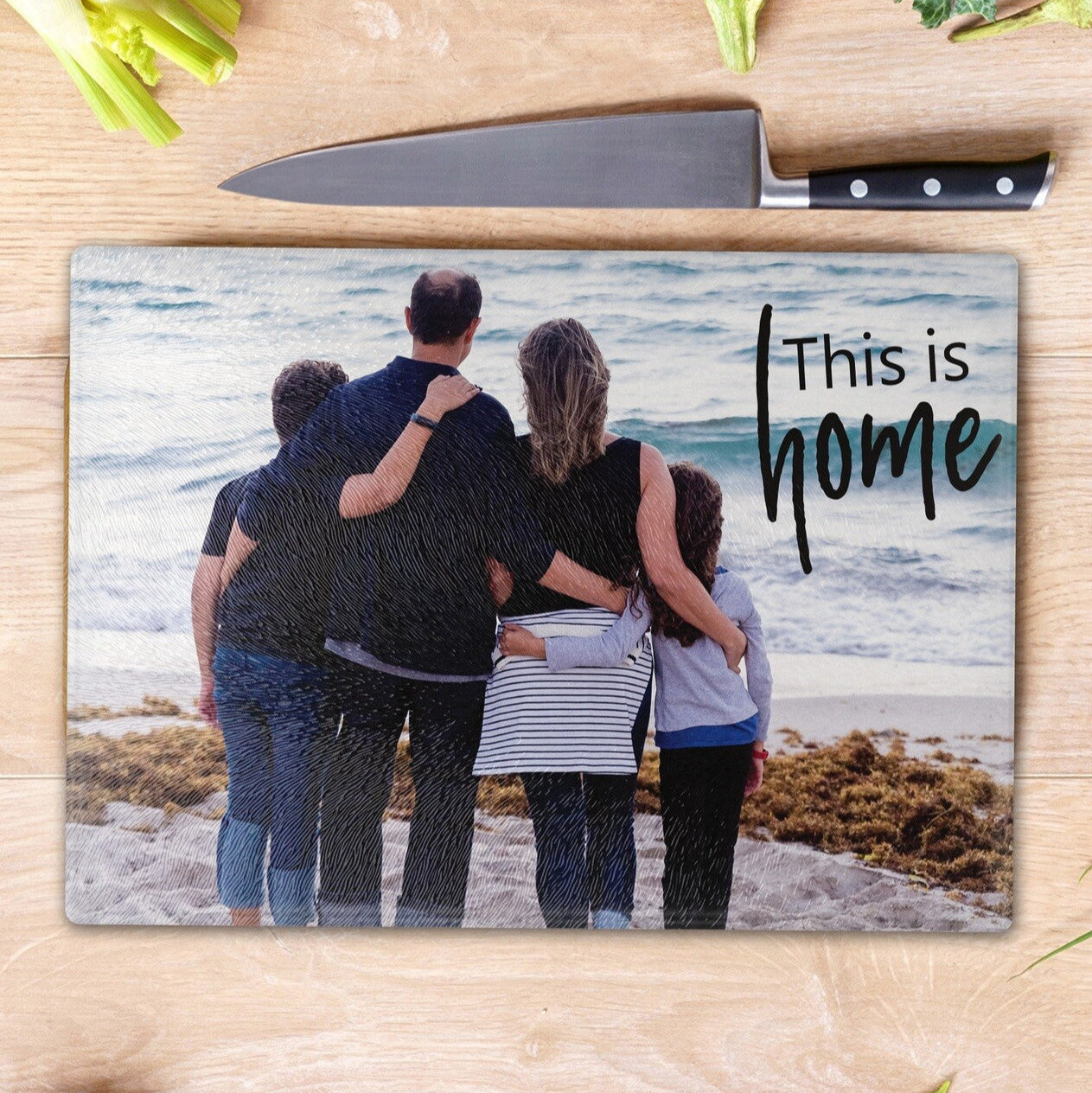 Personalised Cutting Board from Happy Look | South Africa – Unique cutting board featuring a heartwarming illustration of a family of four standing together by the ocean, their backs facing the viewer, with the touching words "This is home" overlaying the image. Perfect for housewarmings, anniversaries, or special family occasions and customisable with names or a personal message. A thoughtful gift that brings joy and lasting memories. Shop now!