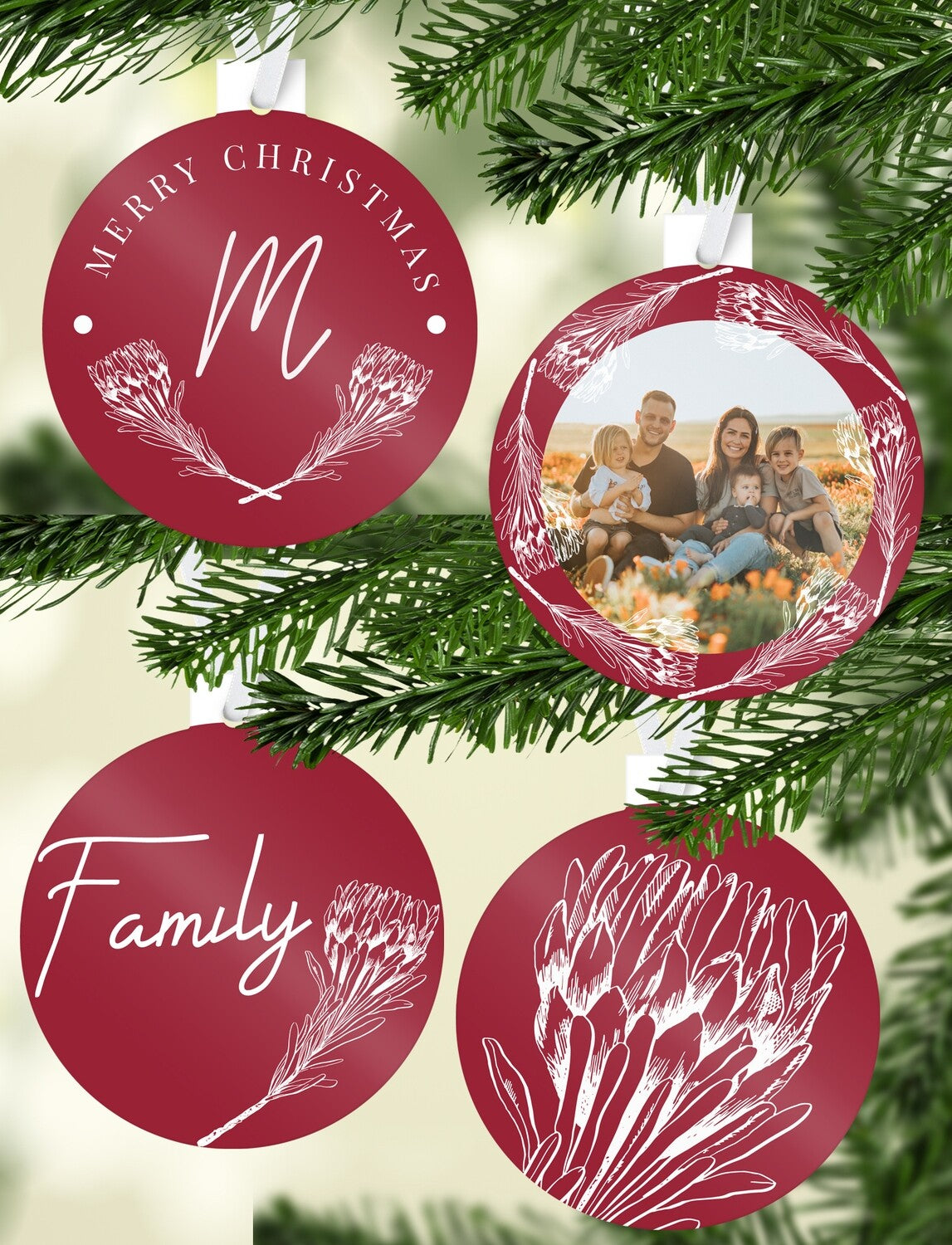 Red Protea Christmas Bauble Set "Family" from Happy Look | South Africa – A set of four circular red ornaments with white protea art. The set includes a family photo, "MERRY CHRISTMAS" with an initial 'M', the word "Family," and a large protea drawing.